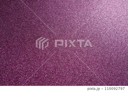 Light on a purple lilac pink violet surface. Bokeh glow. Festive shining background. New Year, Christmas, birthday. Plastic card design. Velvety rough paper, pink cardboard, slightly bent Light on a purple lilac pink violet surface. Bokeh glow. Festive shining background. New Year, Christmas, birthday. Plastic card design. Velvety rough paper, pink cardboard, slightly bent 110092797
