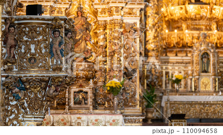 Intricate Gold Leaf Decorations on Baroque Church Altar 110094658