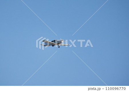 Light single-engine aircraft is in blue sky 110096770