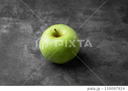 green apple on a black background green apple on a black background 110097924