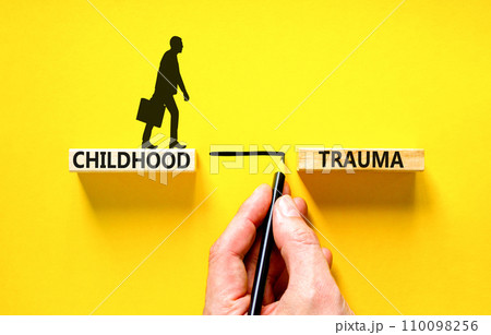 Childhood trauma symbol. Concept words Childhood trauma on beautiful wooden blocks. Beautiful yellow background. Psychologist hand. Business psychology childhood trauma concept. Copy space. 110098256