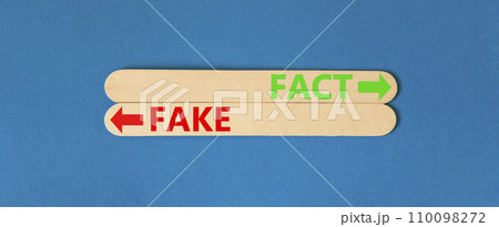 Fact or fake symbol. Concept word Fake and Fact on beautiful wooden stick. Beautiful blue table blue background. Business and fact or fake concept. Copy space. 110098272