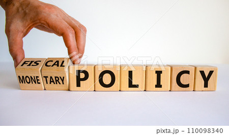 Fiscal or monetary policy symbol. Hand turns cubes and changes words 'fiscal policy' to 'monetary policy'. Beautiful white background. Business and fiscal or monetary policy concept. Copy space. 110098340