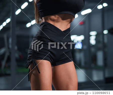 Faceless woman doing vacuum exercise in the gym. Faceless woman doing vacuum exercise in the gym. 110098651