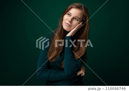 30 year old pretty European woman hopes for good and dreams on a dark background 110098746