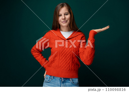 Cheerful 30 year old woman with brown hair points with her hand to the news Cheerful 30 year old woman with brown hair points with her hand to the news 110098816