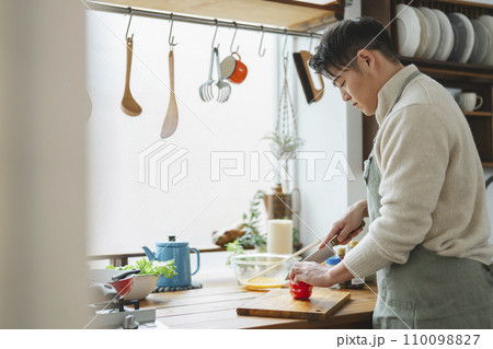 キッチンで料理をする30代半ばの男性 キッチンで料理をする30代半ばの男性 110098827