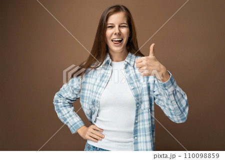 Active young Caucasian woman with long brown hair waving her arms 110098859