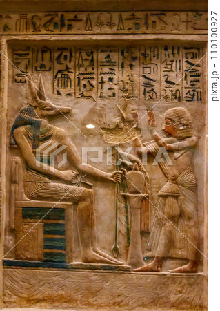 Ancient egyptian paintings and hieroglyphs carved on the stone wall 110100927