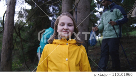 Happy Caucasian woman looks at camera during trekking trip in mountains 110101960