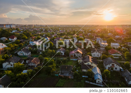 Aerial view of residential houses in suburban rural area at sunset Aerial view of residential houses in suburban rural area at sunset 110102665
