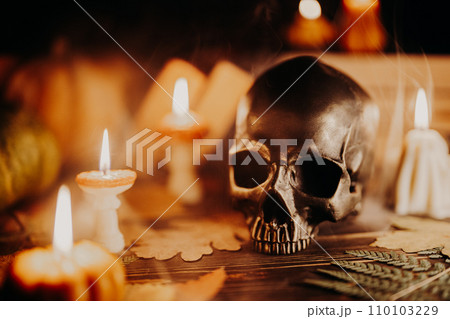 Mystique background - bronze human skull with candles. Visual gothic aesthetic. 110103229