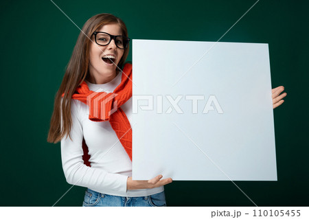 Cute young woman in glasses holds a board and shows business tasks on it 110105455