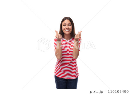 young smiling stylish european brunette woman dressed in striped clothes on a white background 110105490