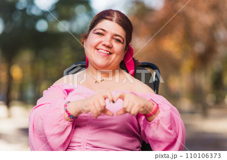 InspireInclusion heart shape, love valentine gesture. Young woman with cerebral palsy disability. InspireInclusion heart shape, love valentine gesture. Young woman with cerebral palsy disability. 110106373