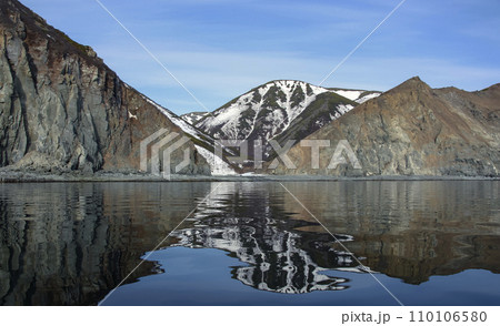 Mountain and sky landscape on coast of Sea Okhotsk in early summer. Mountain and sky landscape on coast of Sea Okhotsk in early summer. 110106580