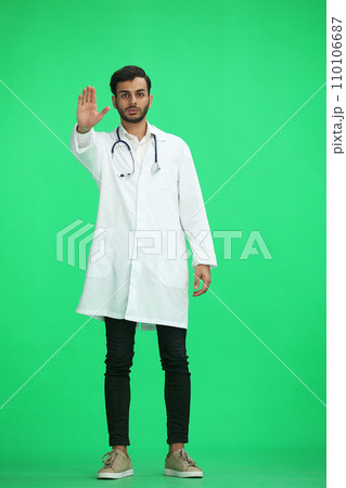 male doctor on a green background. shows stop sign 110106687