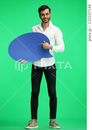 full-length man on a green background holding a sign comment full-length man on a green background holding a sign comment 110107148