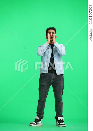 A man on a green background screams 110107202