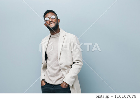Cheerful african man wearing glasses jean jacket having white snow smile pointing fingers aside at copy space for your text advertisement, advertise teeth whitening or eyewear store good offer concept Cheerful african man wearing glasses jean jacket having white snow smile pointing fingers aside at copy space for your text advertisement, advertise teeth whitening or eyewear store good offer concept 110107679