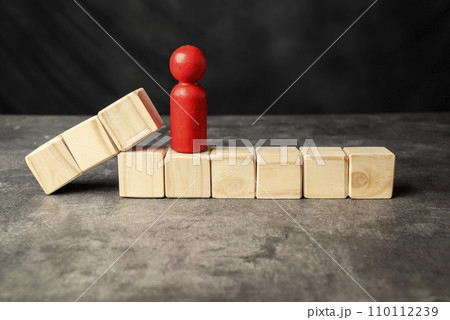 A wooden figure and a row of wooden cubes A wooden figure and a row of wooden cubes 110112239