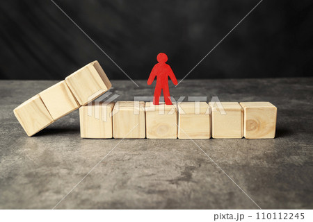 A wooden figure and a row of wooden cubes 110112245