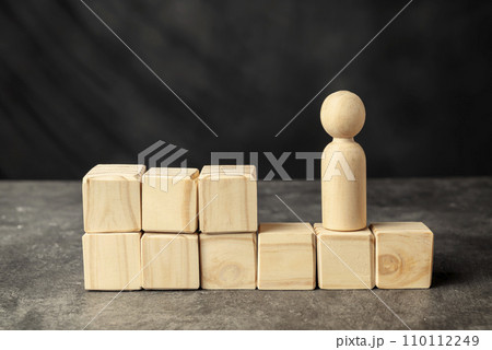 A wooden figure and a stack of wooden cubes 110112249
