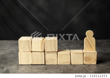 A wooden figure and a stack of wooden cubes A wooden figure and a stack of wooden cubes 110112253