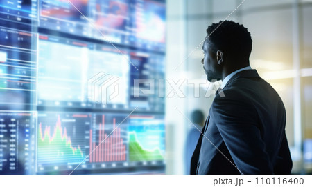 Businessman watching the market reaction on monitors in the exchange hall, real-time trading, financial analysis Businessman watching the market reaction on monitors in the exchange hall, real-time trading, financial analysis 110116400