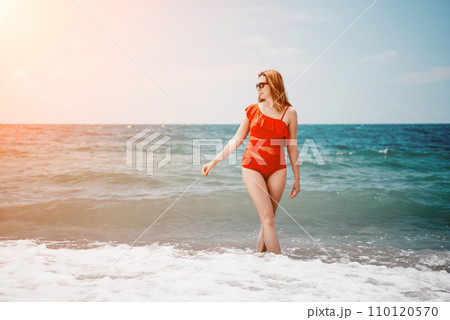 Happy loving family mother and daughter having fun together on the beach. Mum playing with her kid in holiday vacation next to the ocean - Family lifestyle and love concept 110120570
