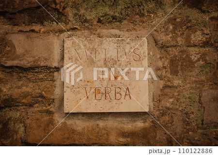 Old plaster brick wall texture with sign board with vintage latin text inscription background, brick wall texture  110122886
