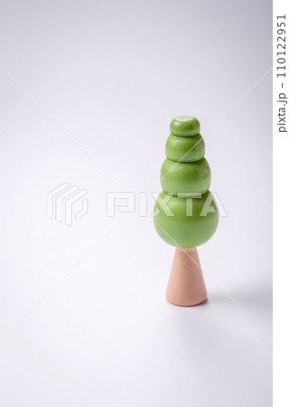 Wooden model of a tree with a green crown and trunk on a white background Wooden model of a tree with a green crown and trunk on a white background 110122951