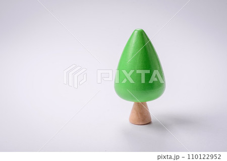 Wooden model of a tree with a green crown and trunk on a white background Wooden model of a tree with a green crown and trunk on a white background 110122952