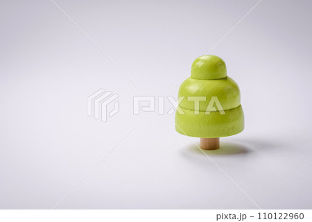 Wooden model of a tree with a green crown and trunk on a white background Wooden model of a tree with a green crown and trunk on a white background 110122960
