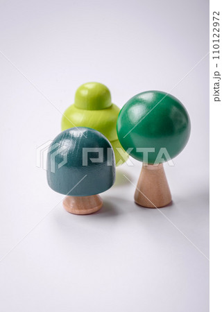 Wooden model of a tree with a green crown and trunk on a white background 110122972