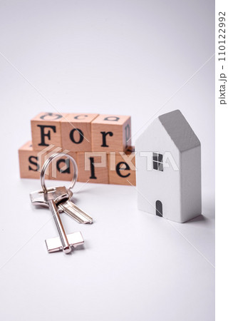 A small wooden house and keys as an idea for investing in your own home 110122992