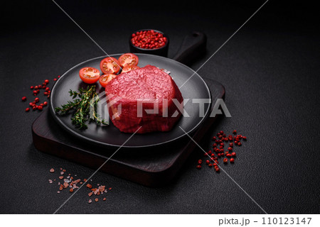 Fresh juicy raw filet mignon with salt, spices and herbs 110123147