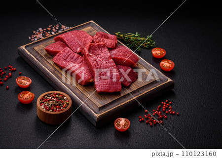 Juicy fresh raw beef meat with salt, spices and herbs 110123160