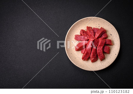 Juicy fresh raw beef meat with salt, spices and herbs 110123182