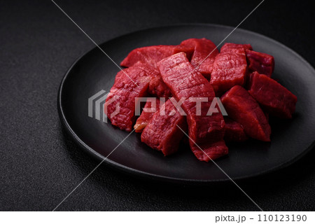 Juicy fresh raw beef meat with salt, spices and herbs 110123190