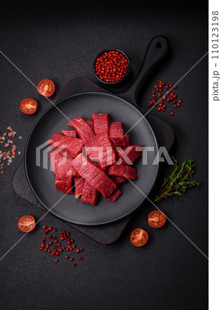 Juicy fresh raw beef meat with salt, spices and herbs 110123198