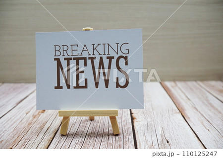 Breaking News word with alarm clock on wooden background 110125247