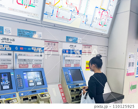 Konohana Ward, Osaka, Japan. Dec 24, 2023. A person getting a ticket at a Japan Rail fare station. Konohana Ward, Osaka, Japan. Dec 24, 2023. A person getting a ticket at a Japan Rail fare station. 110125925