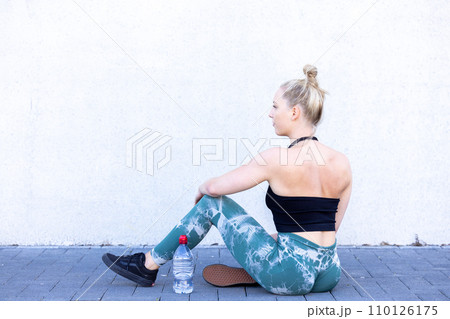Young Woman Resting After Workout in Urban Setting 110126175