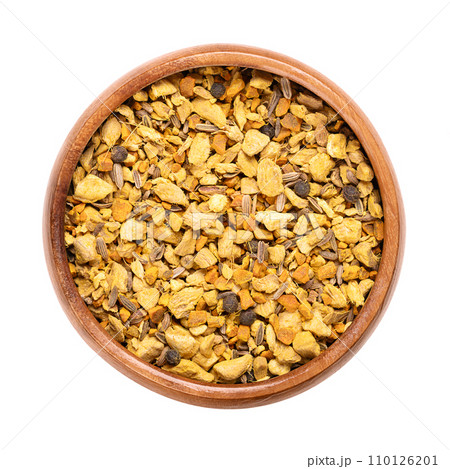 Ginger and turmeric herbal tea, in a wooden bowl. Mix of the dried and shredded anti-inflammatory spices ginger, turmeric, and galangal. Whole fennel seeds and black peppercorns were also added. Photo 110126201