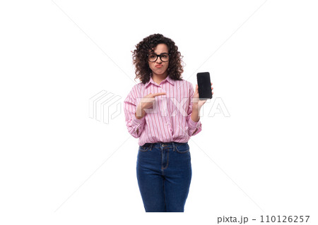 young charming caucasian woman with curly hair dressed in a striped shirt advertises a phone with a 110126257