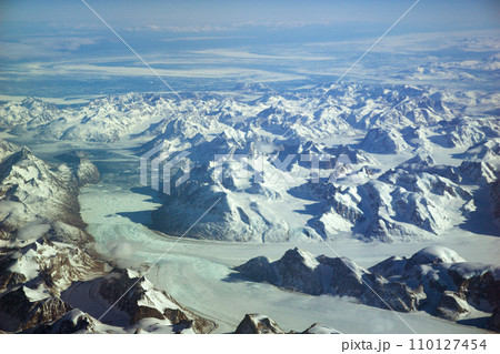 GREENLAND - 10 MAY 2018: View from the aircraft window of icy landscape with glaciers and snow-capped mountains of Greenland 110127454
