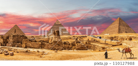 Great Pyramids of Giza and the Sphinx, bedouin with a camel, beautiful panorama of Cairo region, Egypt Great Pyramids of Giza and the Sphinx, bedouin with a camel, beautiful panorama of Cairo region, Egypt 110127988