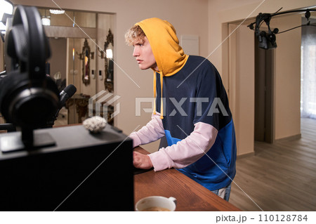 Young active guy in his room Young active guy in his room 110128784