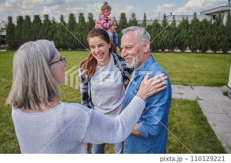 Senior woman talking with her grey haired husband and young daughter 110129221